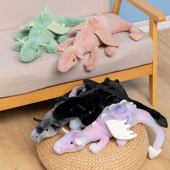Plush dragon toys in various colors on a chair and stool.